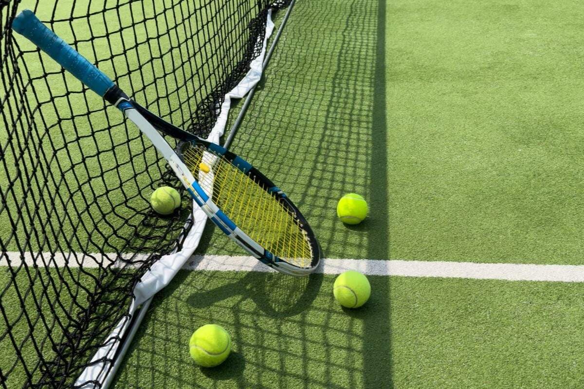 Tennis court with net, racket, and balls